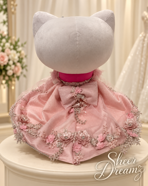 Back view of blush pink Hello Kitty quinceañera dress with large bow