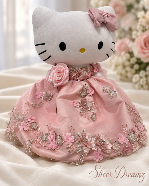 Blush pink quinceañera doll dress with rose, beadwork, and floral appliqué
