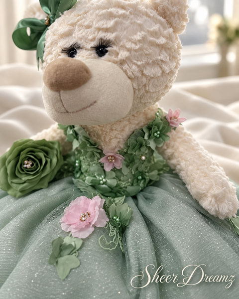 Sage green quinceañera teddy bear dress with blush flowers and beadwork detail